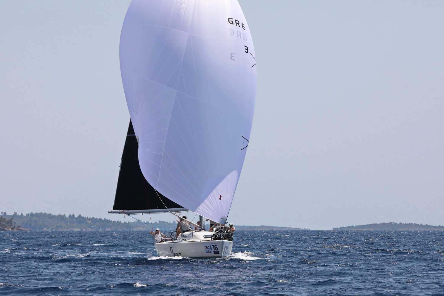 sailing boat white spinnaker sail from the front view.